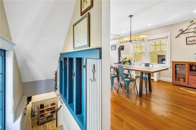 interior space with lofted ceiling, a chandelier, and light hardwood / wood-style floors