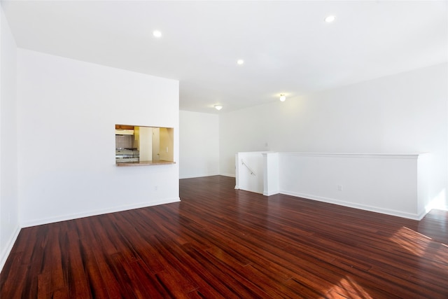 unfurnished living room with dark hardwood / wood-style flooring