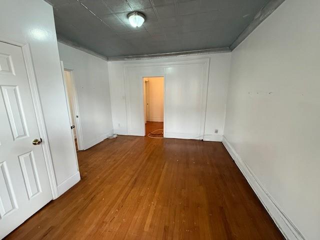 empty room with wood-type flooring