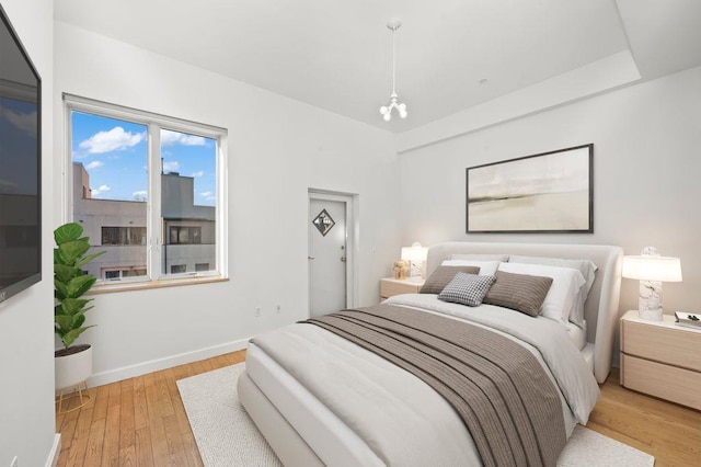 bedroom featuring light wood-type flooring and baseboards