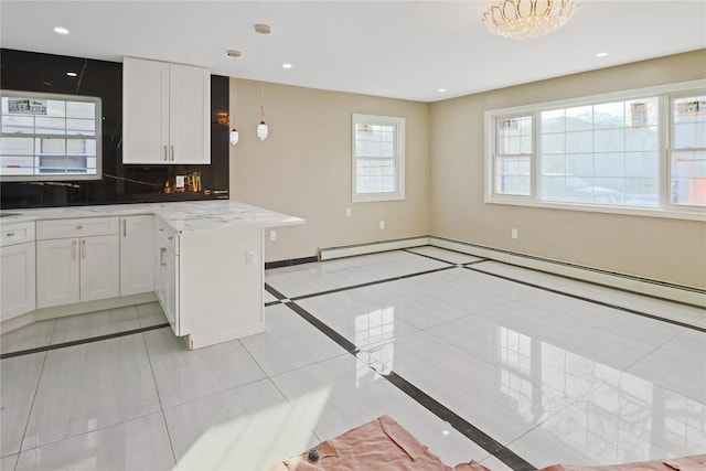 kitchen featuring white cabinetry, backsplash, pendant lighting, and light tile patterned flooring