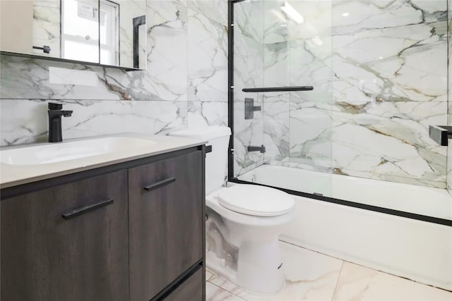 full bathroom featuring vanity, bath / shower combo with glass door, tile walls, and toilet