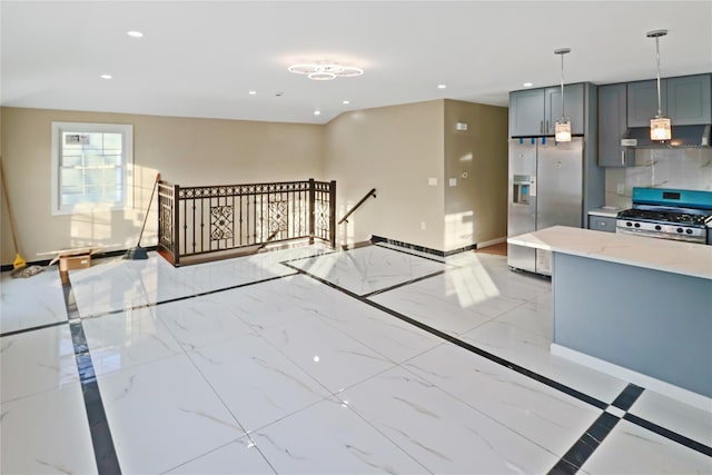 kitchen with light stone counters, gray cabinets, pendant lighting, stainless steel appliances, and exhaust hood