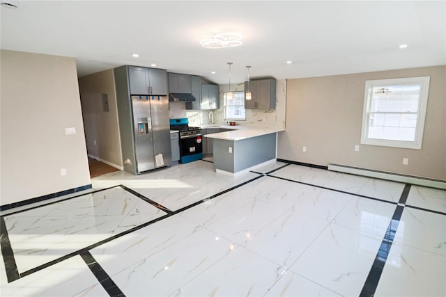 kitchen featuring appliances with stainless steel finishes, pendant lighting, tasteful backsplash, gray cabinetry, and baseboard heating