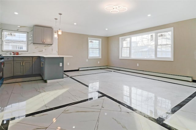 kitchen featuring gray cabinets, decorative light fixtures, tasteful backsplash, a baseboard radiator, and light stone countertops