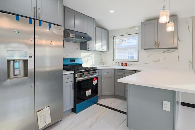 kitchen featuring gray cabinets, appliances with stainless steel finishes, sink, and decorative light fixtures