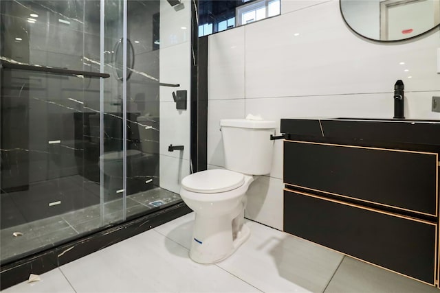 bathroom featuring tile walls, tile patterned flooring, vanity, walk in shower, and toilet