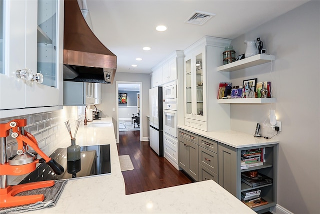 kitchen with sink, white appliances, white cabinetry, backsplash, and extractor fan