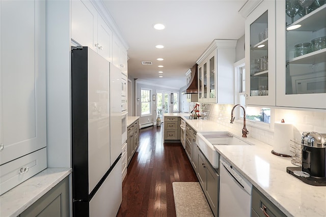 kitchen featuring white cabinetry, dishwasher, sink, and light stone counters