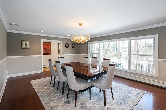 dining space featuring crown molding, dark hardwood / wood-style floors, and an inviting chandelier