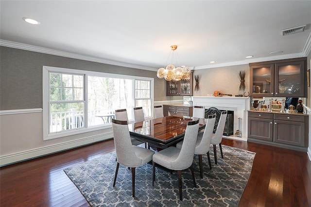 dining area with dark hardwood / wood-style flooring, crown molding, an inviting chandelier, and baseboard heating