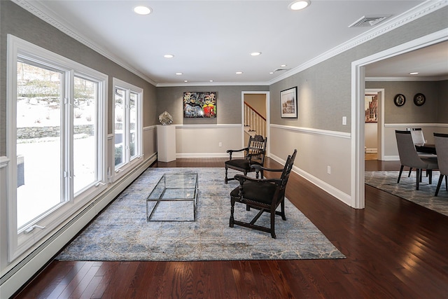 living area featuring baseboard heating, ornamental molding, and dark hardwood / wood-style floors