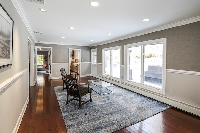 interior space with a baseboard heating unit, ornamental molding, and dark wood-type flooring