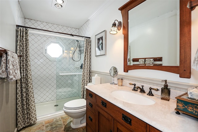 bathroom with vanity, a tile shower, crown molding, and toilet