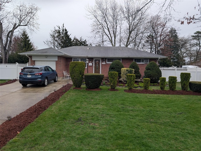 ranch-style home with brick siding, fence, a garage, concrete driveway, and a front yard
