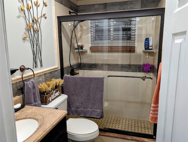 full bath featuring vanity, toilet, and a shower stall