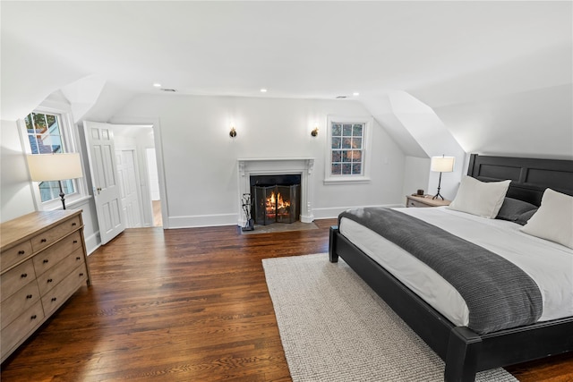 bedroom with vaulted ceiling and dark wood-type flooring