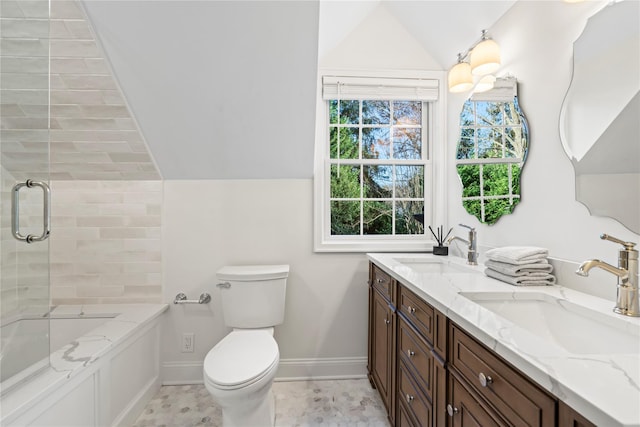 bathroom with toilet, vanity, a shower with door, and vaulted ceiling