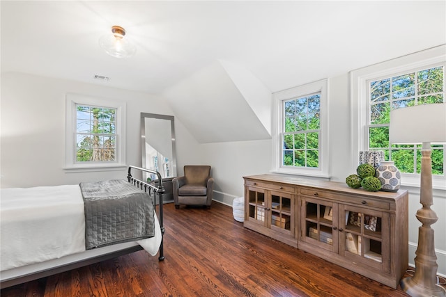 bedroom with vaulted ceiling and dark hardwood / wood-style floors