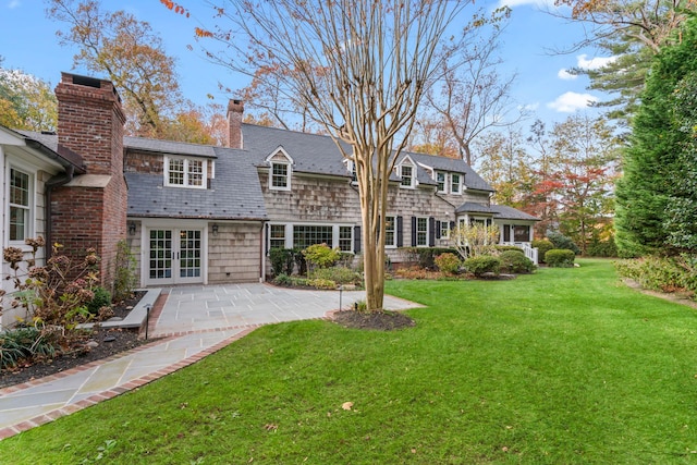 back of property featuring a lawn, french doors, and a patio area