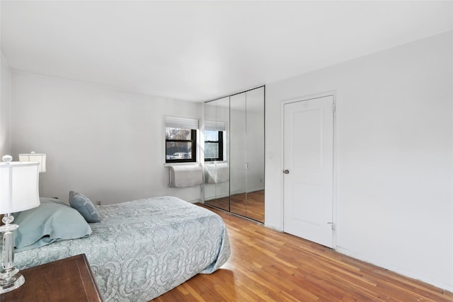 bedroom with wood-type flooring and a closet