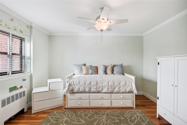 bedroom featuring dark hardwood / wood-style flooring, radiator heating unit, ornamental molding, and ceiling fan