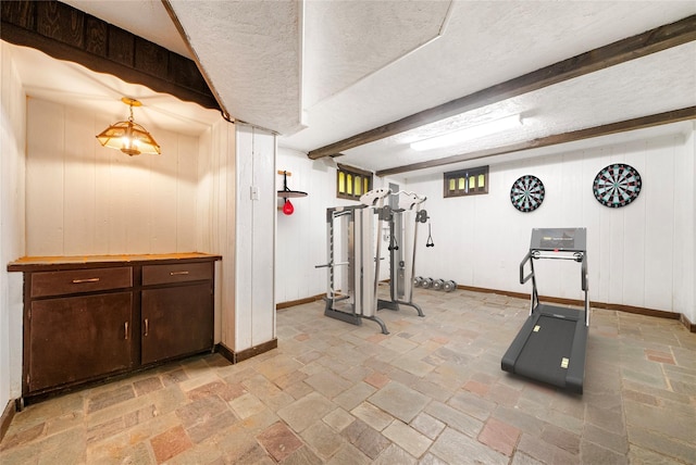 workout room with a textured ceiling