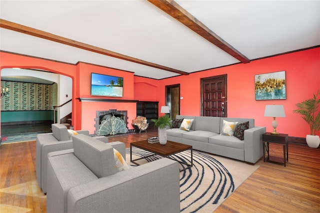 living room with beam ceiling and wood-type flooring