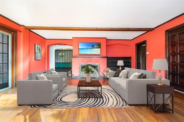 living room with wood-type flooring and beam ceiling