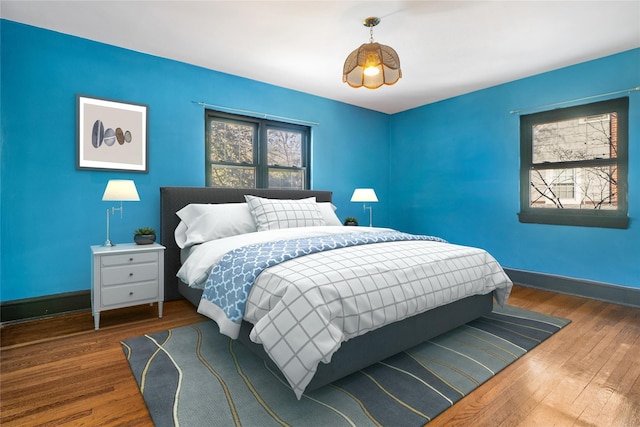 bedroom with dark wood-type flooring