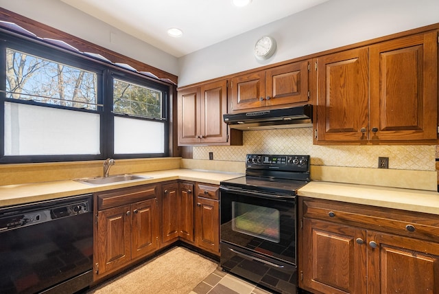 kitchen with tasteful backsplash, sink, and black appliances