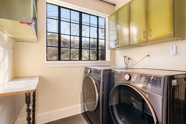 laundry area featuring cabinets and washing machine and dryer