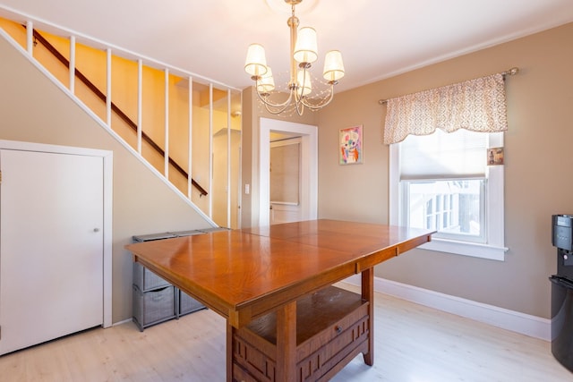 dining space with an inviting chandelier and hardwood / wood-style flooring