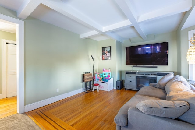 living room with beamed ceiling, coffered ceiling, and light wood-type flooring