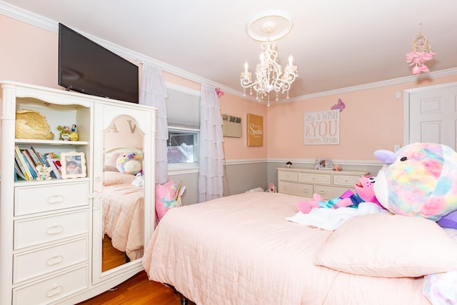 bedroom with crown molding, light hardwood / wood-style floors, and a chandelier