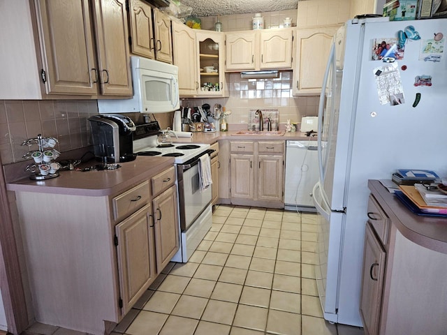 kitchen with light brown cabinetry, sink, tasteful backsplash, light tile patterned floors, and white appliances