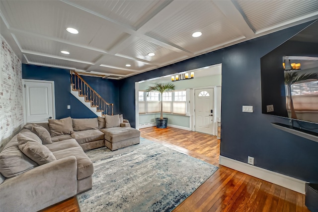 living room with a baseboard heating unit, wood-type flooring, coffered ceiling, and beam ceiling