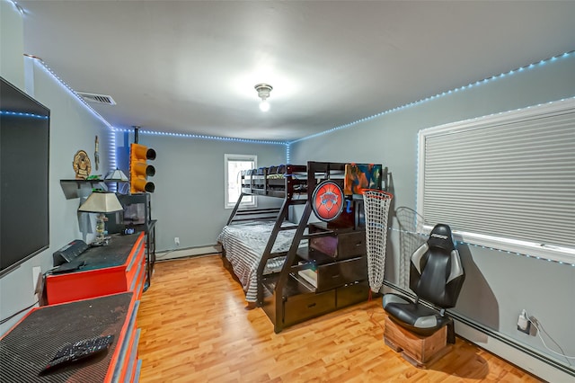 bedroom featuring a baseboard radiator and wood-type flooring