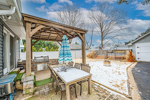 view of patio with exterior kitchen, a gazebo, and a grill