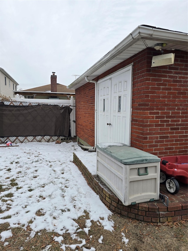 view of snow covered property entrance