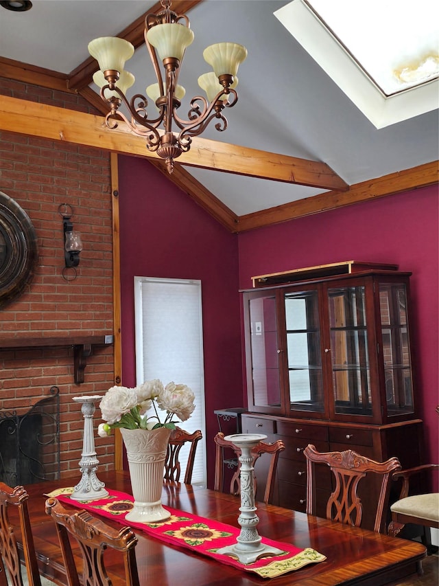 dining area featuring an inviting chandelier, lofted ceiling with skylight, and a brick fireplace