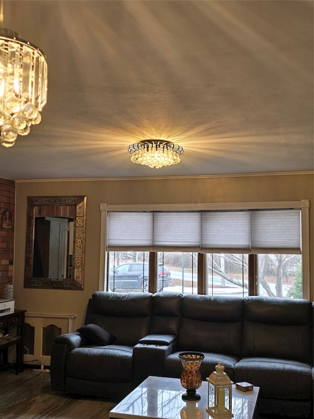 living room featuring an inviting chandelier and wood-type flooring