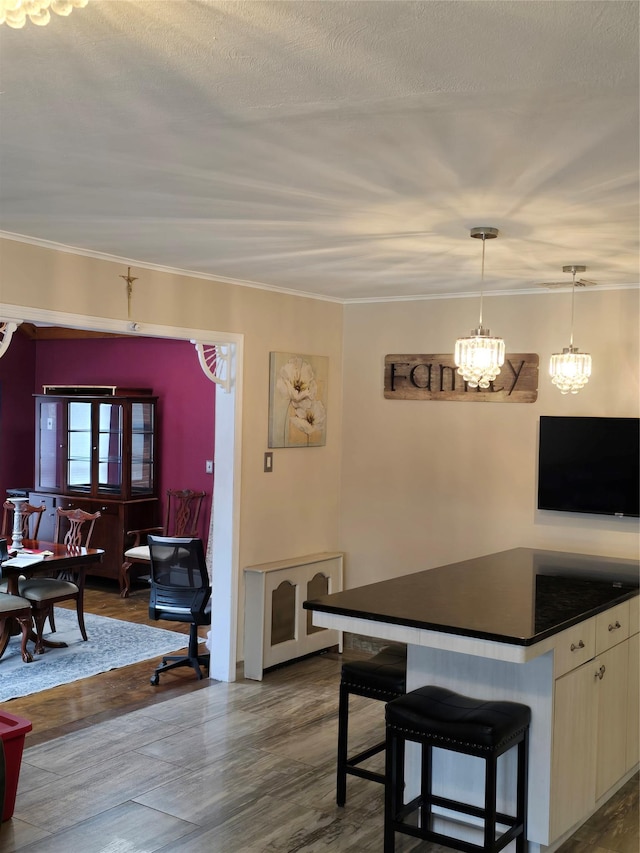 dining space featuring hardwood / wood-style floors, crown molding, and a textured ceiling