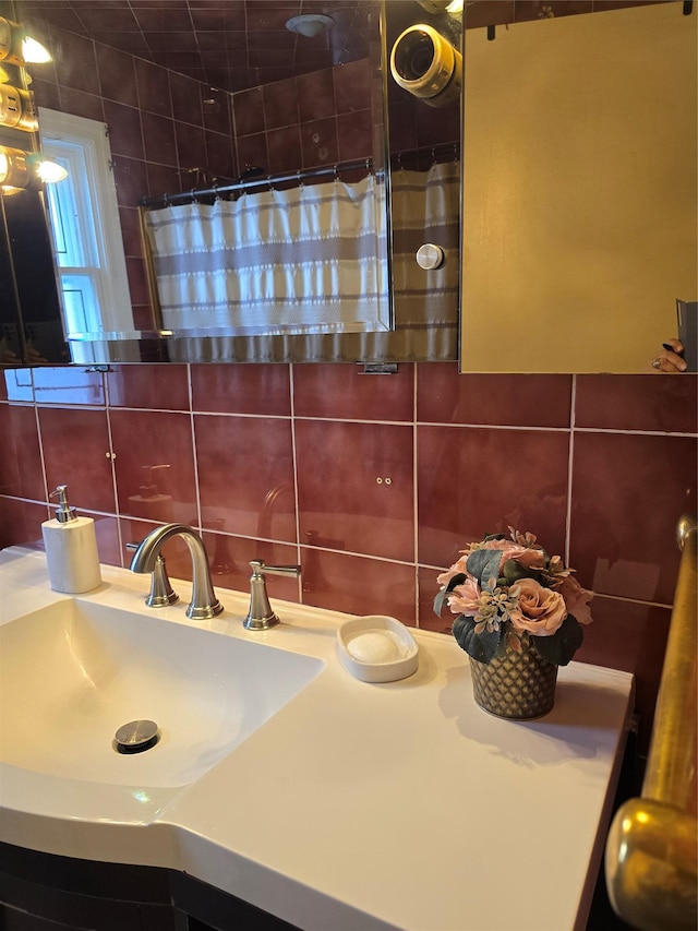 bathroom with tasteful backsplash, sink, tile walls, and a shower with curtain