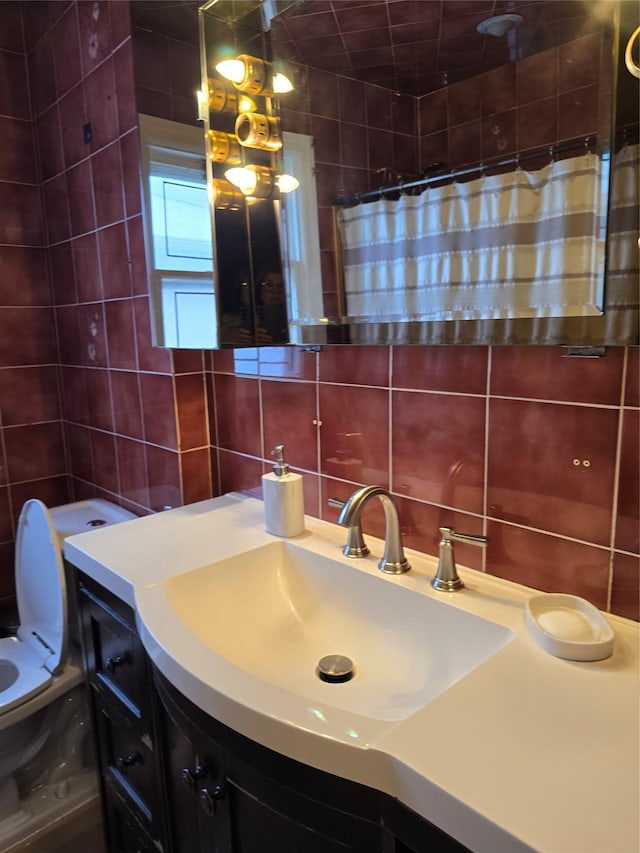 bathroom featuring walk in shower, toilet, tasteful backsplash, tile walls, and vanity