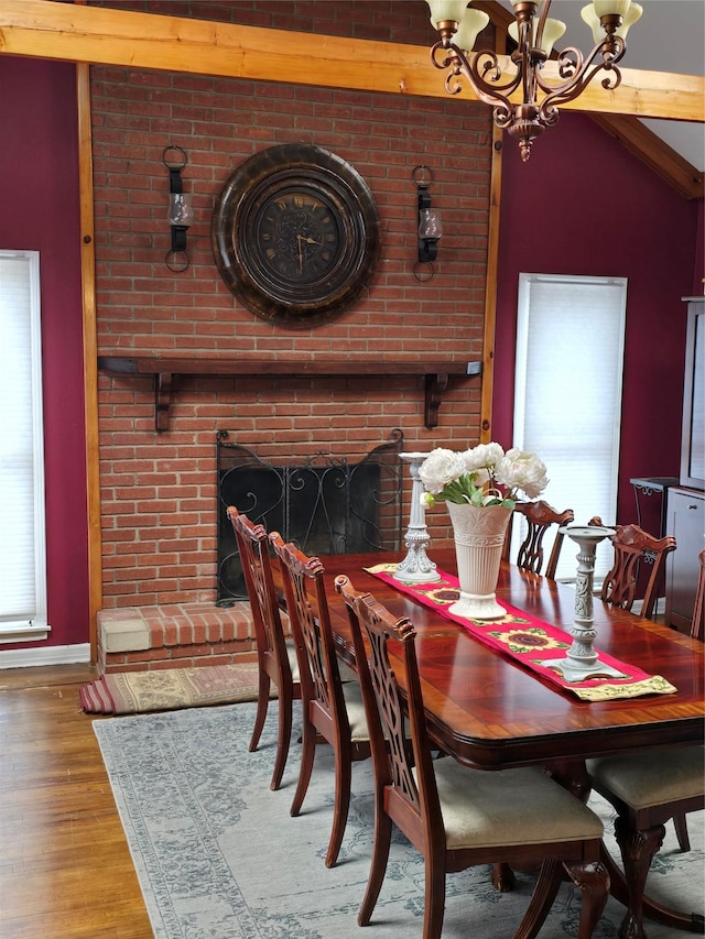15731 80th St, Howard Beach, NY 11414 - dining area featuring baseboards, wood finished floors, and an inviting chandelier