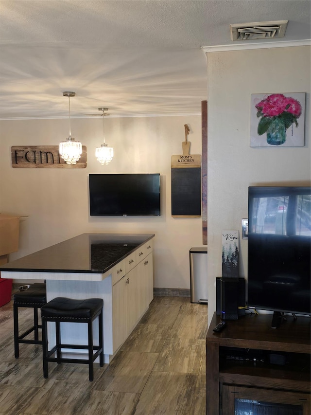 15731 80th St, Howard Beach, NY 11414 - interior space with ornamental molding, dark countertops, a kitchen bar, and visible vents