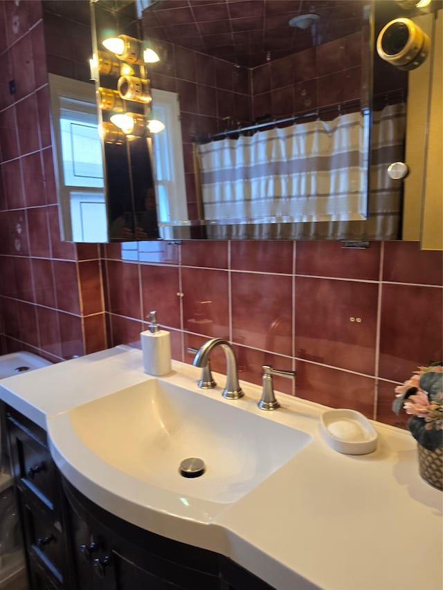 15731 80th St, Howard Beach, NY 11414 - bathroom featuring tile walls, curtained shower, vanity, and backsplash