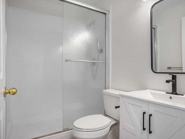 bathroom with vanity, walk in shower, and toilet