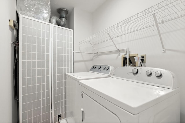 laundry area with independent washer and dryer